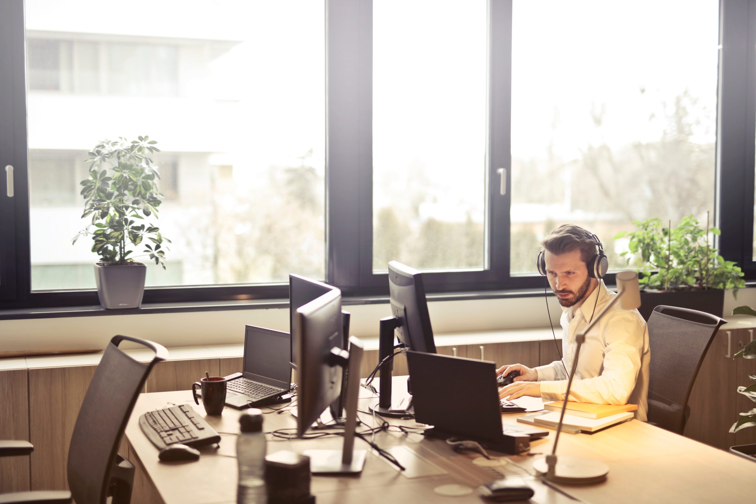 Man with headphones on in office