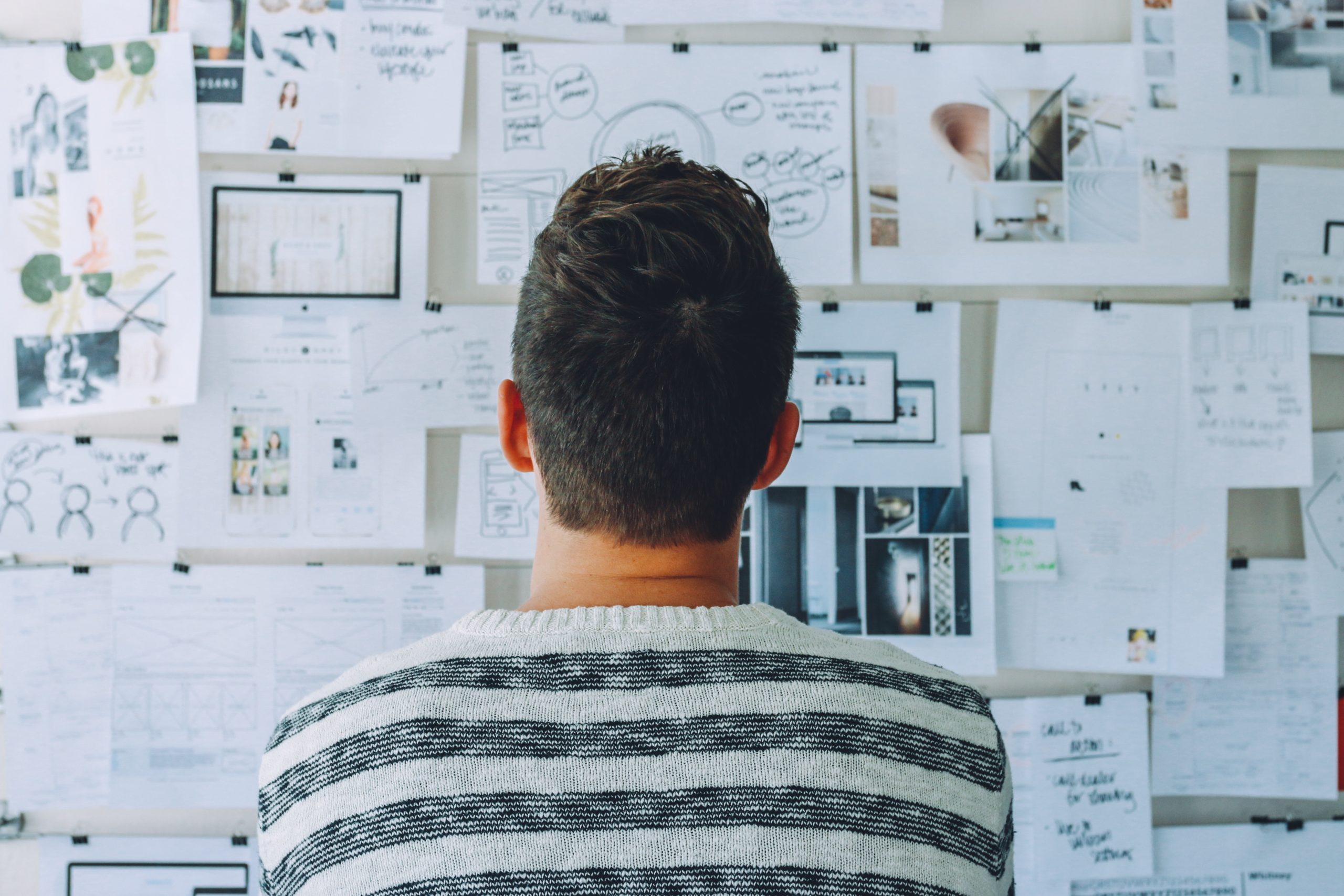 man looking at moodboard