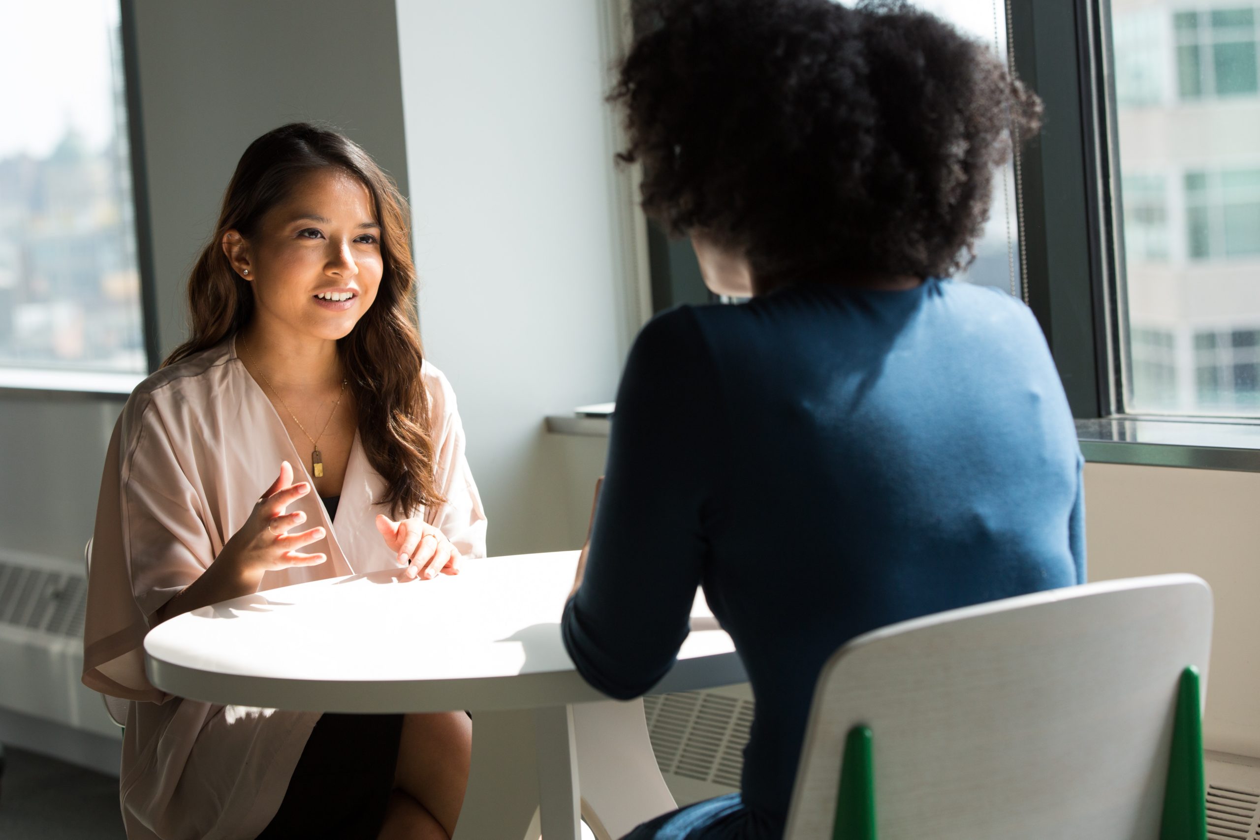 two women in conversation across the table