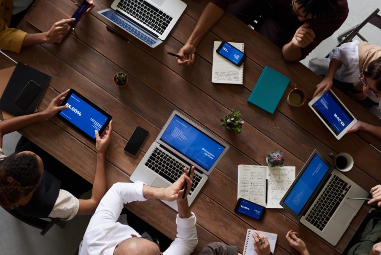 Birds eye view of people sat around a table during a business meeting