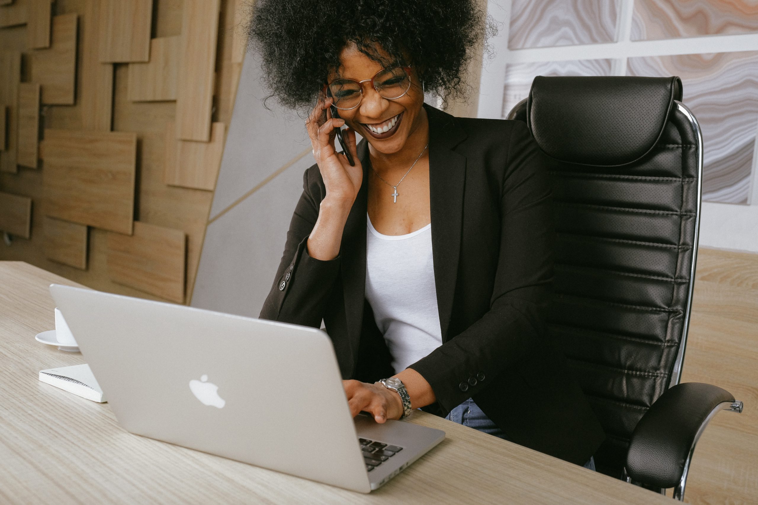 Business woman sat at desk on phone