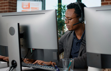 Man with headset on sat at desk