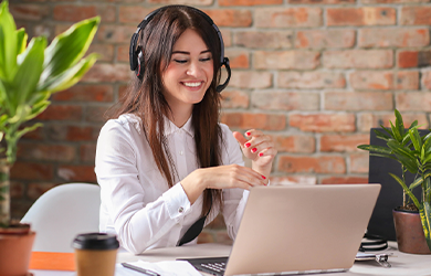 Woman sat with headset on at laptop