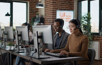Two people sat at desks in office
