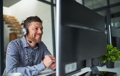 Man working at call centre talking with customer