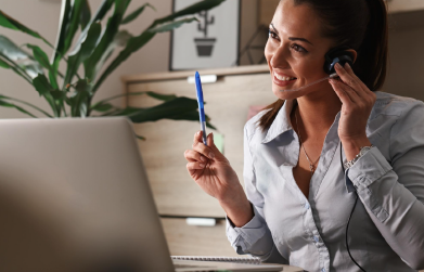 happy customer service representative with headset communicating with a customer while appointment setting