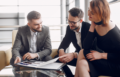 three professionals sat at a table segmenting their audience